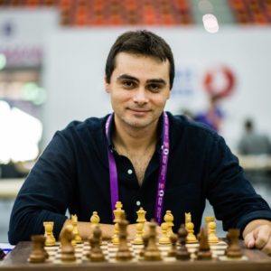 Ntirlis nikolaos is sitting in front of a chess board