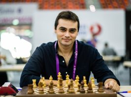 Ntirlis nikolaos is sitting in front of a chess board